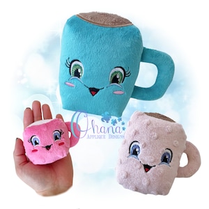 May include: Three plush toy mugs with smiling faces. The mugs are turquoise, pink and beige. The turquoise mug has a brown rim and a brown handle. The pink mug has a white rim and a white handle. The beige mug has a brown rim and a brown handle.