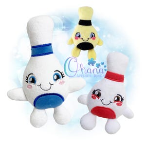 May include: Three plush bowling pin characters with embroidered faces, rosy cheeks, and arms. One is white with blue accents, one is white with red accents, and one is yellow with black accents. The text Ohana Applique Designs is visible.