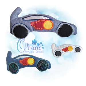 May include: Two plush toy racing cars, one blue and one white, with red and yellow accents. The blue car has a black tyre with a galaxy design. The white car has a black tyre with a solid design.