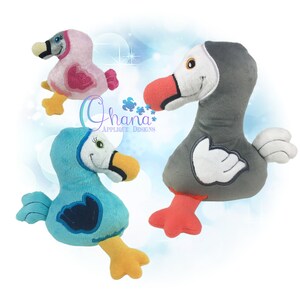 May include: Three plush toy birds in different colours. A pink bird with a heart on its chest, a blue bird with a blue wing, and a grey bird with a white wing. The birds are all standing on a white background.