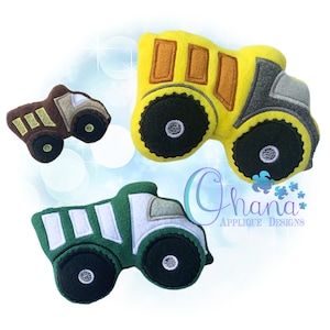 May include: Three colourful felt toy trucks in yellow, brown, and green. The yellow truck has brown details, the brown truck has tan details, and the green truck has white details. Each truck has large black wheels.