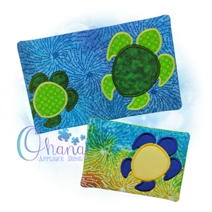 May include: Two fabric pouches with a blue and green tie-dye pattern. The pouches feature a green and blue applique of a turtle with a yellow centre.