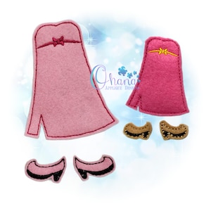 May include: Two pink felt dress-up outfits with gold trim and a pair of black felt shoes. The outfits are for a doll or small child.