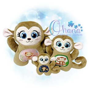 May include: Three plush monkey toys of different sizes. The largest monkey is brown with pink accents and has large blue eyes. The middle monkey is brown with green accents and has large blue eyes. The smallest monkey is brown with blue accents and has large blue eyes. All three monkeys have embroidered details and are holding a smaller monkey toy.