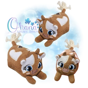 May include: Three plush brown and white cow plushies with embroidered eyes and a heart on their sides. The plushies are lying on a blue background with white stars.