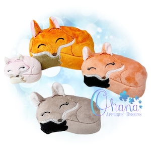 May include: Three plush fox toys in different colors: orange, peach, and gray. Each fox is curled up sleeping with its eyes closed and a small smile. The foxes are made of soft, fuzzy fabric and have embroidered details.