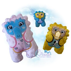 May include: Three plush toys in the shape of a cartoon animal with a long beak. The toys are pink, blue, and yellow. The pink toy has a blue beak and is wearing a pink and blue bib with the word "Baby" on it. The blue toy has a blue beak and is wearing a blue and white bib with polka dots. The yellow toy has a yellow beak and is wearing a yellow and blue bib with a dog on it.