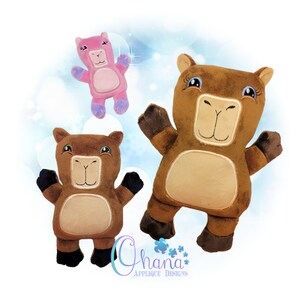 May include: Three plush toys, two brown and one pink, with embroidered faces and large eyes. The brown toys are standing with their arms raised, while the pink toy is floating in the air. The toys are all smiling and have a friendly appearance.
