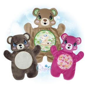 May include: Three plush bear-shaped items featuring embroidered faces with large eyes and circular center panels. The top bear is tan, the left is dark gray with a plain center, and the right is bright pink with a patterned center featuring small bears.