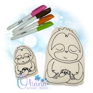 May include: Two beige sloth-shaped applique designs with black stitched outlines, one large and one small, are displayed. Four colored markers in pink, brown, orange, and green are positioned above the appliques. The image includes the text "Ohana Applique Designs".