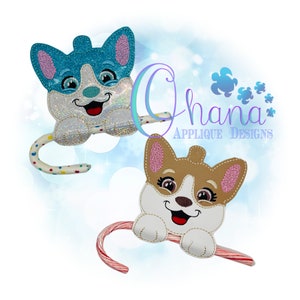 May include: Two adorable dog-shaped candy cane holders. One is blue and white with pink ears, the other is brown and white with pink ears. Both have a candy cane attached to the bottom.