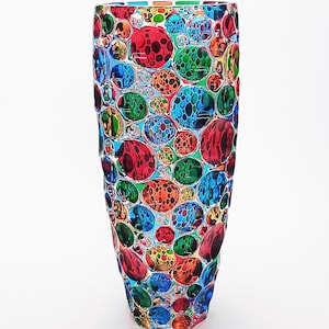 May include: A tall, clear glass vase with a textured surface. The vase is decorated with a pattern of colorful, round, bubble-like shapes in shades of red, blue, green, orange, and yellow.