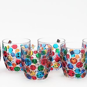May include: Set of six clear glass tumblers with a colorful polka dot design. Each tumbler features a unique pattern of red, orange, yellow, green, blue, and purple dots.