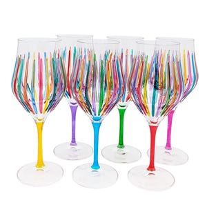 May include: A set of six clear wine glasses with colorful vertical stripes. Each glass has a different colored stem: yellow, purple, blue, green, red, and pink. The glasses are arranged on a white background.