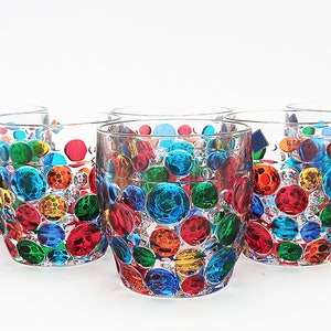 May include: Set of six clear glass tumblers with a colorful, multi-colored, bubble design. The glasses are perfect for everyday use or for special occasions.