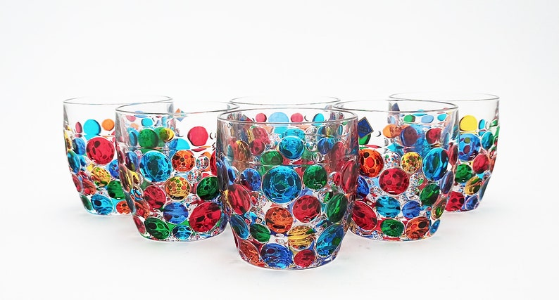 May include: Set of six clear glass tumblers with a colorful, multi-colored, bubble design. The glasses are perfect for everyday use or for special occasions.