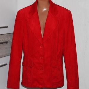 May include: A red corduroy blazer with a notched collar, two pockets, and a button closure.