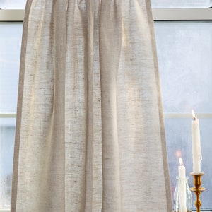 May include: A natural linen valance with a gathered top and a simple, straight bottom edge. The valance is hanging in a window with two candles on the windowsill.