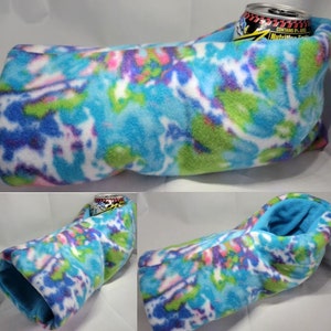 May include: A blue, green, pink, and white tie-dye fleece can cozy. The cozy is designed to hold a can of beverage. The cozy is shown in three different positions.