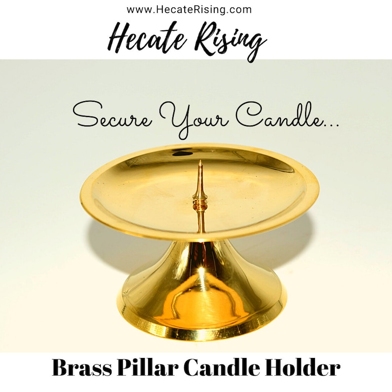 May include: A gold brass pillar candle holder with a round base and a central spike for securing a candle.  Secure Your Candle... www.HecateRising.com