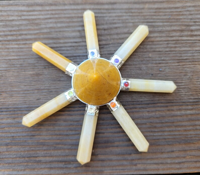 May include: A yellow crystal chakra set with seven chakra stones. The set includes a yellow crystal pyramid and six yellow crystal points.