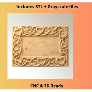 May include: A light-colored wooden frame with a carved heart design around the edges. The frame has a rectangular opening and includes the text "Includes STL + Grayscale files" and "CNC & 3D Ready".