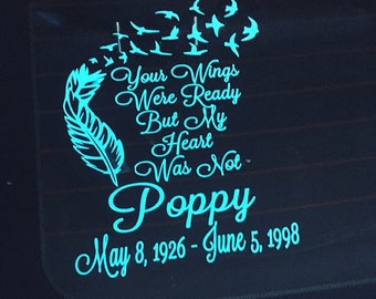 May include: A teal blue car window decal with a feather and the text "Your Wings Were Ready But My Heart Was Not Poppy May 8, 1926 - June 5, 1998".
