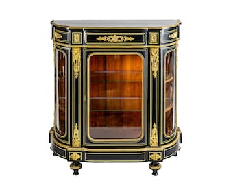 May include: A black and gold antique display cabinet with glass doors and shelves. The cabinet has ornate details and a curved base.