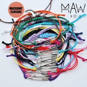 May include: A stack of colorful friendship bracelets with arrow charms. The bracelets are made of thin cord and have a macrame closure. The text "MAKE A WISH" is visible in the background.
