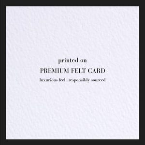 A sample of the felt textured natural white cardstock. Reads: printed on premium felt card. Luxury feel; responsibly sourced.