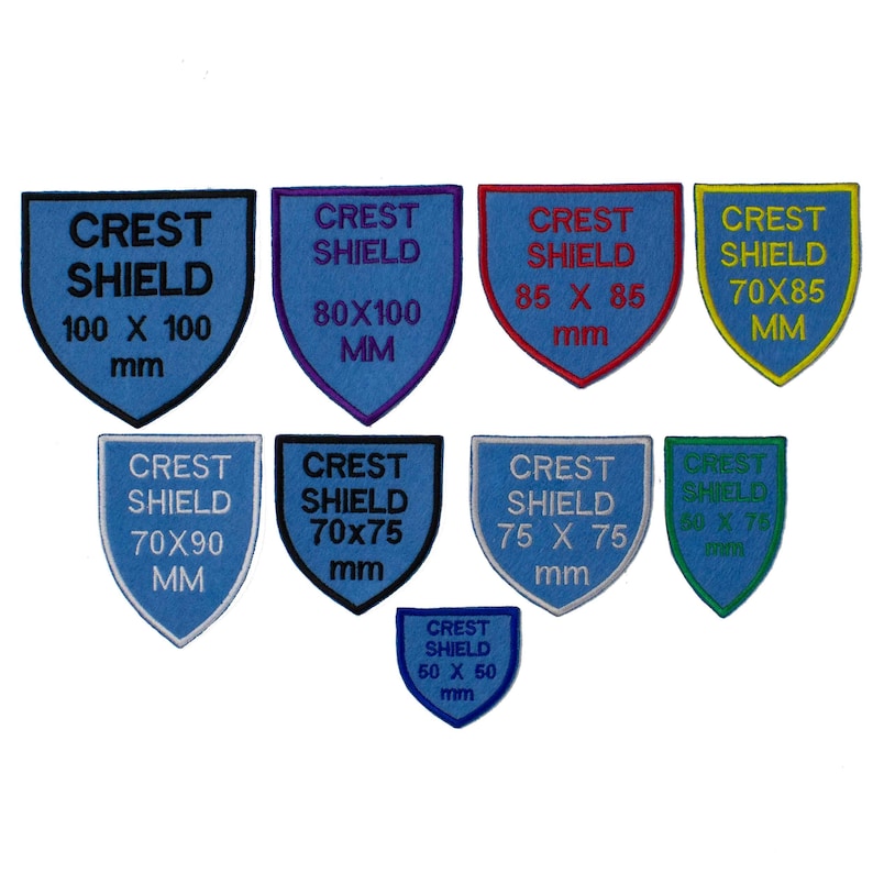 May include: A set of nine blue, green, yellow, and red embroidered crest shield patches in various sizes. The patches feature the text "Crest Shield" and the dimensions of each patch in millimetres.