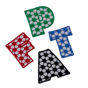 May include: Four felt letters, "F", "A", "T", and "P", each with a white and black football pattern. The letters are red, black, blue, and green.