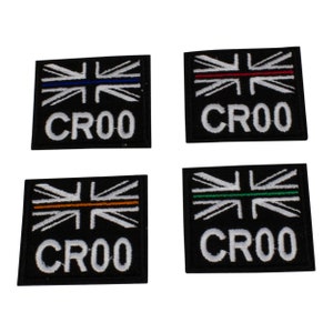 May include: Four black embroidered patches with a white Union Jack design and a thin coloured stripe across the middle. Each patch has the text "CR00" in white.