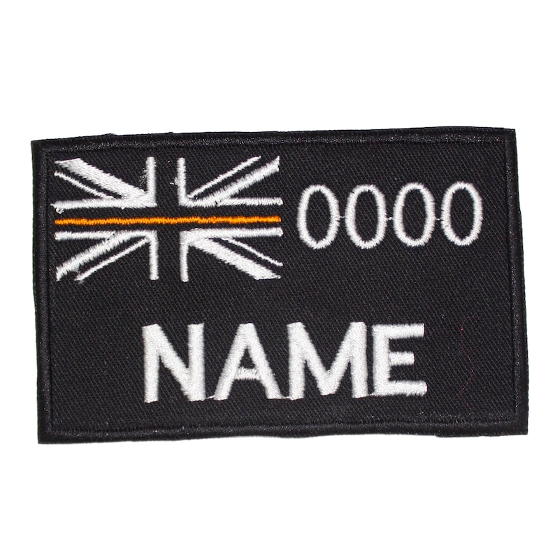 May include: Black embroidered patch with a white Union Jack flag with an orange stripe across the middle, the number 0000, and the word NAME in white.