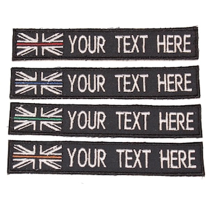May include: Four black embroidered patches with a white Union Jack flag and a thin coloured stripe across the flag. The text "YOUR TEXT HERE" is embroidered in white below the flag.