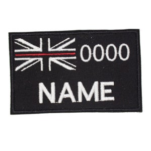 May include: Black embroidered patch with a red line through a white Union Jack flag, the number 0000, and the word NAME in white.