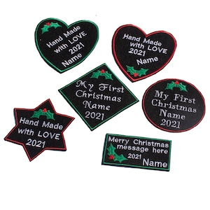 May include: Six black iron-on patches with white and red embroidery. The patches feature a variety of Christmas themes, including "Hand Made with Love 2021", "My First Christmas Name 2021", and "Merry Christmas message here 2021 Name".