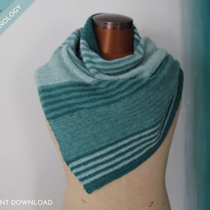 May include: A teal and light green crochet shawl with stripes. The shawl is draped over a mannequin.