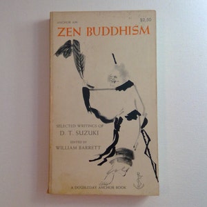 May include: A vintage paperback book titled "Zen Buddhism" by D.T. Suzuki, edited by William Barrett. The cover features a black and white illustration of a person in traditional Japanese clothing holding a branch with leaves.