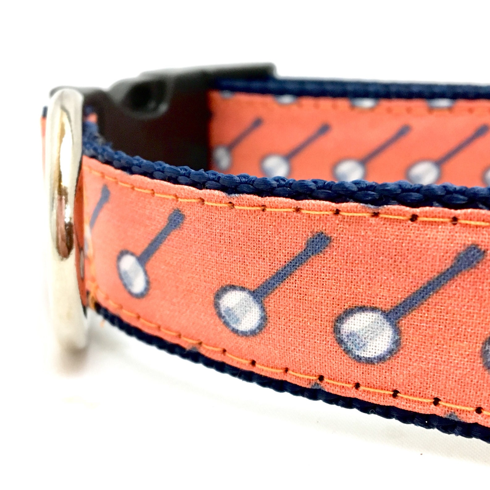 light red dog collar with banjos printed on it
