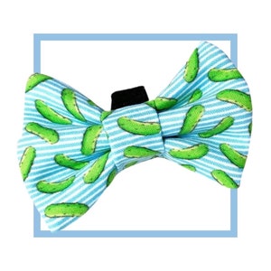 May include: A blue and green bow tie with a pattern of green pickles on a white and blue striped background.