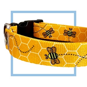 May include: Yellow dog collar with a honeycomb pattern and black and yellow bees. The collar has a black plastic buckle.