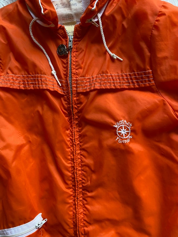 bright orange windbreaker