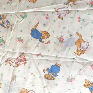 May include: White fabric with a repeating pattern of cartoon animals, including cats, rabbits, and geese, dressed in clothing. The design also features small pink and green floral accents scattered across the surface.