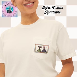 May include: White t-shirt with a pocket featuring a graphic of two cartoon rats wearing hats. The text "More Colors Available" is in the top right corner of the image.