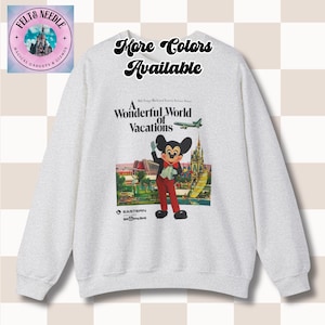 May include: A light gray sweatshirt featuring a graphic of Mickey Mouse in a vintage travel poster style. The poster reads "A Wonderful World of Vacations" with the text "More Colors Available" above the graphic. The sweatshirt has long sleeves.