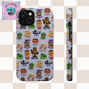 Puede incluir: Funda de teléfono azul claro con un patrón repetido de personajes de los Muppets, incluyendo a Kermit, Miss Piggy y Animal. La funda tiene un acabado brillante y un diseño protector, con una vista lateral que muestra el grosor de la funda.