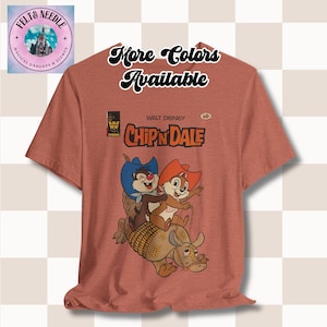 May include: A red t-shirt with a vintage comic book design featuring Chip 'n Dale riding an armadillo. The comic book cover reads "Walt Disney Chip 'n Dale" and has a price tag of 60 cents.