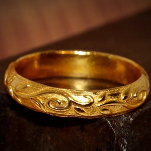 24k ring with a floral pattern.