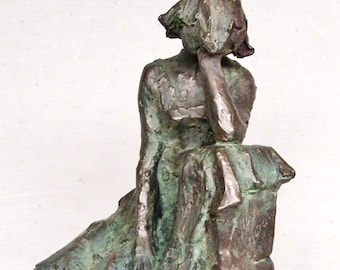 Original figure,   woman seated on a pedestal